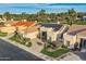 Lovely aerial view of home with solar panels and manicured lawns, surrounded by mature trees at 8334 E Jenan Dr, Scottsdale, AZ 85260