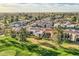 Expansive aerial view of a golf course community with well-maintained lawns and diverse home styles at 8334 E Jenan Dr, Scottsdale, AZ 85260