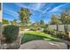 Serene backyard featuring lush landscaping, artificial turf, and stone patio, perfect for relaxation at 8334 E Jenan Dr, Scottsdale, AZ 85260