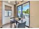 Cozy dining area with patio access, modern light fixture, and neutral color palette at 8334 E Jenan Dr, Scottsdale, AZ 85260