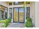 Stunning black and gold double front door with decorative windows and manicured landscaping at 8334 E Jenan Dr, Scottsdale, AZ 85260