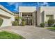 Welcoming single-story home featuring desert landscaping, manicured lawn, and inviting front entrance at 8334 E Jenan Dr, Scottsdale, AZ 85260