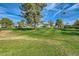 Expansive golf course view with mature trees, manicured green and luxury homes in background at 8334 E Jenan Dr, Scottsdale, AZ 85260