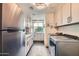 Well-equipped laundry room featuring modern appliances and plenty of cabinet space at 8334 E Jenan Dr, Scottsdale, AZ 85260