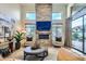 Bright living room with fireplace, stone accent wall, and neutral furniture at 8334 E Jenan Dr, Scottsdale, AZ 85260