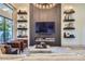 Comfortable living room with contemporary fireplace and statement chandelier at 8334 E Jenan Dr, Scottsdale, AZ 85260