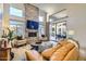 Bright living room with fireplace, stone accent wall, and patio access at 8334 E Jenan Dr, Scottsdale, AZ 85260