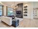 Bright living room featuring modern fireplace and built-in shelving at 8334 E Jenan Dr, Scottsdale, AZ 85260