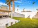 Landscaped backyard, artificial turf, and patio area at 8626 E Mackenzie Dr, Scottsdale, AZ 85251