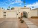 Mid-century modern home with a landscaped front yard and gated entry at 8626 E Mackenzie Dr, Scottsdale, AZ 85251