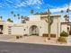 Mid-century modern home with a landscaped front yard and gated entry at 8626 E Mackenzie Dr, Scottsdale, AZ 85251