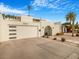 Mid-century modern home with a landscaped front yard and gated entry at 8626 E Mackenzie Dr, Scottsdale, AZ 85251