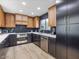 Modern kitchen with wood and dark cabinetry, quartz countertops, and stainless steel appliances at 8626 E Mackenzie Dr, Scottsdale, AZ 85251