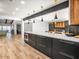 Open concept kitchen with island, wood and dark cabinetry, and stainless steel appliances at 8626 E Mackenzie Dr, Scottsdale, AZ 85251