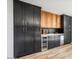 Modern kitchen with dark cabinetry and wine cooler at 8626 E Mackenzie Dr, Scottsdale, AZ 85251