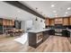 Open concept kitchen with island, wood and dark cabinetry, and stainless steel appliances at 8626 E Mackenzie Dr, Scottsdale, AZ 85251