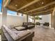 Relaxing covered patio with wicker furniture and stone flooring at 8626 E Mackenzie Dr, Scottsdale, AZ 85251