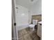 Bathroom with tub, toilet and tile flooring at 8651 W Glenrosa Ave, Phoenix, AZ 85037