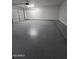 Attached garage with ample space and epoxy floor at 8651 W Glenrosa Ave, Phoenix, AZ 85037