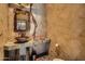 Elegant powder room with a unique vessel sink and textured walls at 9135 E Buckskin Trl, Scottsdale, AZ 85255