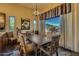 Bright dining area with a rustic wood table and views of the desert landscape at 9135 E Buckskin Trl, Scottsdale, AZ 85255