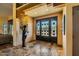 Elegant entryway with arched, iron doors and tiled floors at 9135 E Buckskin Trl, Scottsdale, AZ 85255