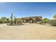 Front view of a beautiful Southwestern style home with a circular driveway at 9135 E Buckskin Trl, Scottsdale, AZ 85255