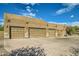 Exterior view of a three-car garage with decorative garage doors at 9135 E Buckskin Trl, Scottsdale, AZ 85255