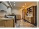 Laundry room with tile floor, wood cabinets, and built-in shelving at 9135 E Buckskin Trl, Scottsdale, AZ 85255