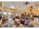 Spacious living room with a stone fireplace and leather furniture at 9135 E Buckskin Trl, Scottsdale, AZ 85255