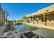 Inviting pool and spa with a waterfall feature, and fire pit at 9135 E Buckskin Trl, Scottsdale, AZ 85255