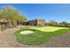 Private putting green in backyard with desert landscaping at 9135 E Buckskin Trl, Scottsdale, AZ 85255