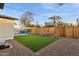 Landscaped backyard with artificial turf and a wooden fence at 929 E Granada Rd, Phoenix, AZ 85006