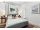 Bright bedroom with a gray platform bed and ensuite bath at 929 E Granada Rd, Phoenix, AZ 85006