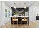 Modern kitchen with white quartz countertops, dark cabinetry, and a breakfast bar at 929 E Granada Rd, Phoenix, AZ 85006