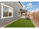 Artificial turf backyard with a gray house exterior at 9354 E Sector Dr, Mesa, AZ 85212