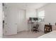 Bedroom with a standing desk, two monitors, and double doors at 9354 E Sector Dr, Mesa, AZ 85212