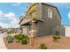 Gray two-story home with stone accents, landscaping, and a two-car garage at 9354 E Sector Dr, Mesa, AZ 85212