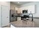 Modern kitchen with stainless steel appliances and granite countertops at 9447 W Glenrosa Ave, Phoenix, AZ 85037