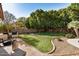 Landscaped backyard with lush lawn and mature trees at 9524 W Running Deer Trl, Peoria, AZ 85383