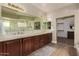 Elegant bathroom with double vanity and walk-in closet at 9524 W Running Deer Trl, Peoria, AZ 85383