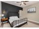 Charming bedroom with dark-wall accent and metal bed frame at 9524 W Running Deer Trl, Peoria, AZ 85383