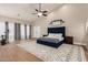 Spacious bedroom with a large bed and wood floors at 9524 W Running Deer Trl, Peoria, AZ 85383