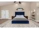 Spacious bedroom with a large bed and wood floors at 9524 W Running Deer Trl, Peoria, AZ 85383