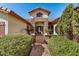 Front entry with brick walkway and lush landscaping at 9524 W Running Deer Trl, Peoria, AZ 85383