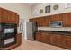 Spacious kitchen with dark wood cabinets and granite countertops at 9524 W Running Deer Trl, Peoria, AZ 85383