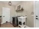 Convenient laundry room with washer, dryer, and utility sink at 9524 W Running Deer Trl, Peoria, AZ 85383