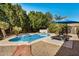 Inviting kidney-shaped pool with brick patio and lounge chairs at 9524 W Running Deer Trl, Peoria, AZ 85383