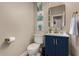 Stylish powder room with navy vanity and gold accents at 9524 W Running Deer Trl, Peoria, AZ 85383