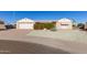 Single story home with a two-car garage and well-maintained landscaping at 9526 W Briarwood N Cir, Sun City, AZ 85351